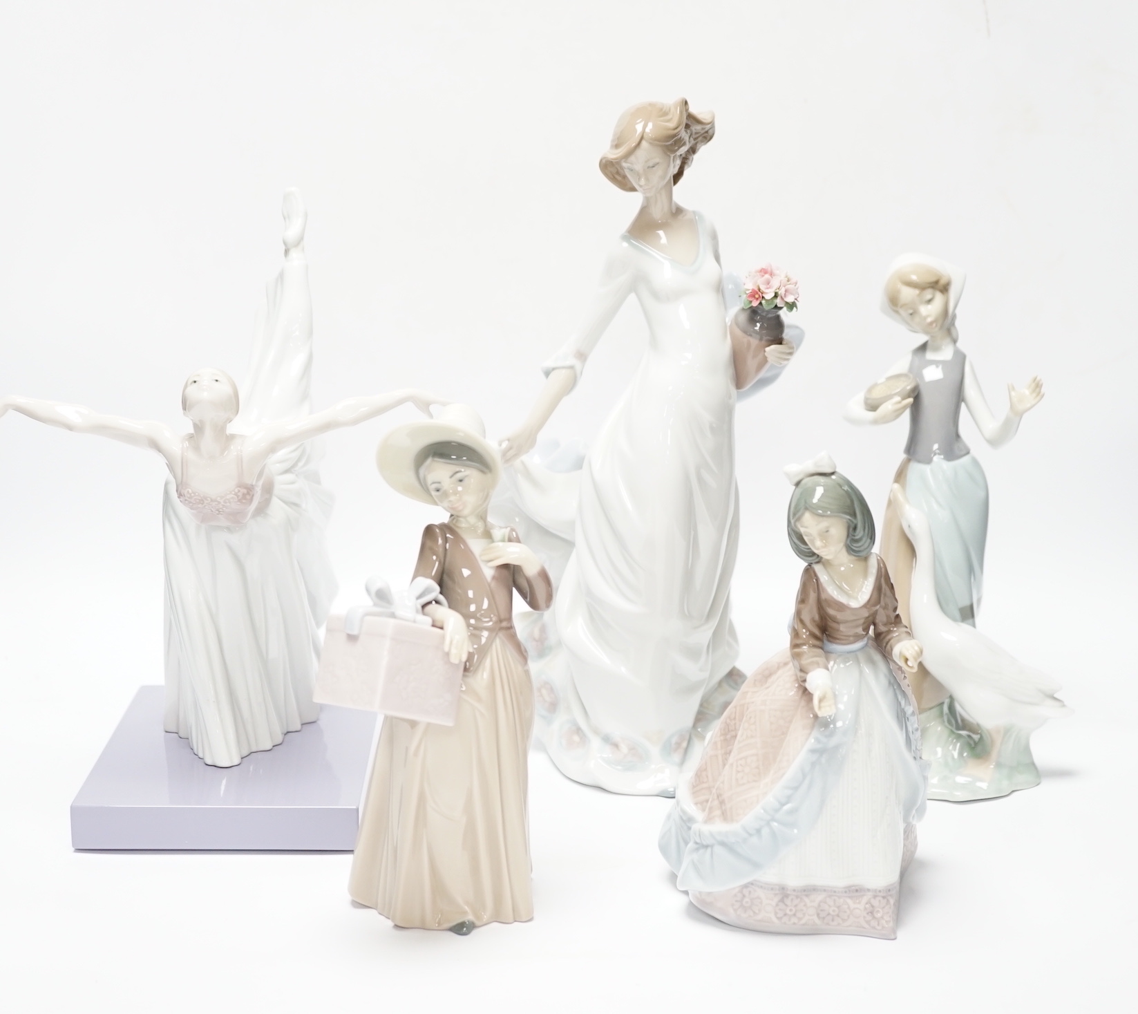Four Lladro figurines; Reverie Moment, a model of a Ballet Dancer, and three other figurines (only two boxed)